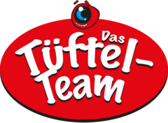 Logo der Tüftel-Team-Lesereihe. Der Text Tüftel-Team steht in weiß auf einem roten Hintergrund. Oben in der Mitte ist ein Roboter-Kopf.
